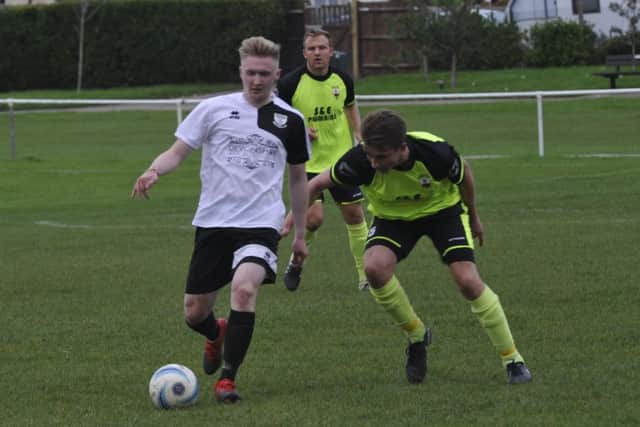 Bexhill United debutant Liam Foster in possession.