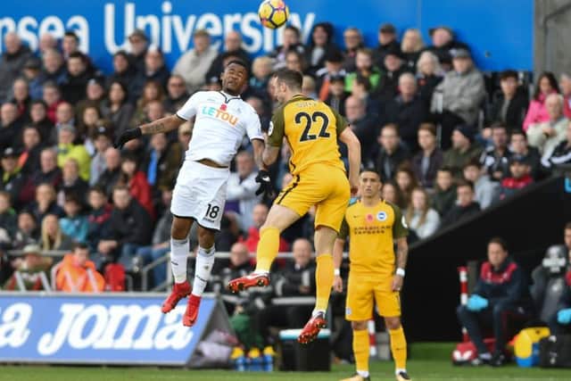 Shane Duffy jumps for a header at Swansea. Picture by Phil Westlake (PW Sporting Photography)
