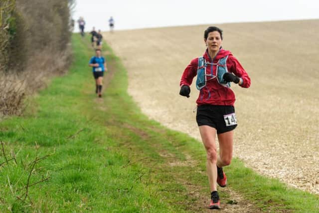 Kelly Jarvis, who was the first woman home in this year's race, heading towards Housedean Farm, 5 miles into the run. Photograph by James McCauley