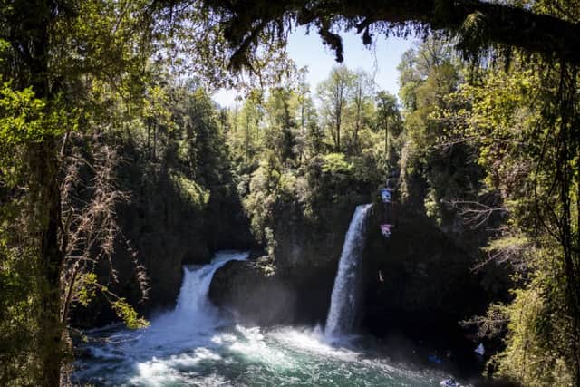 Blake Aldridge of the UK dives from the 27 metre platform during the sixth and final stop of the Red Bull Cliff Diving World Series at Rininahue waterfall, Lago Ranco, Chile on October 21, 2017. // Dean Treml/Red Bull Content Pool // P-20171022-00261 // Usage for editorial use only // Please go to www.redbullcontentpool.com for further information. //