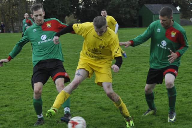 Two Bexhill AAC II players converge on a Ninfield VFC opponent.