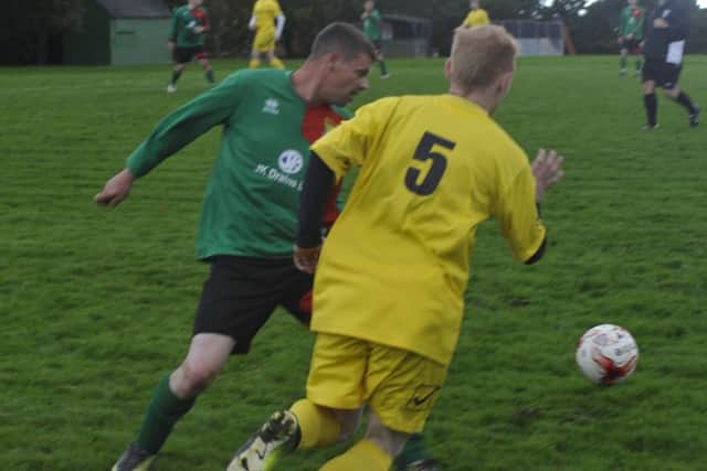 A Ninfield VFC player cuts inside a Bexhill AAC II opponent.