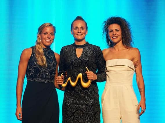 Littlehampton beach soccer star Sarak Kempson (centre) with her best women's player award. Picture courtesy of beachsoccer.com