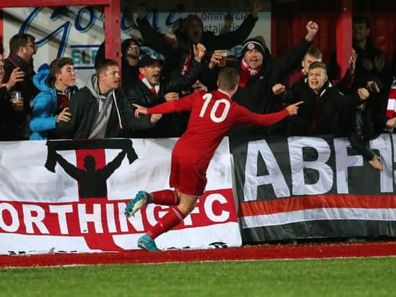 Harvey Sparks celebrates his goal with the Worthing fans. Picture by Mike Gunn