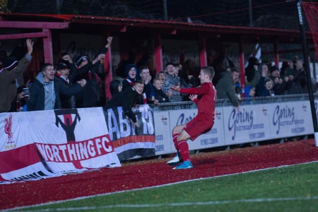 Harvey Sparks celebrates with the Worthing fans. Picture by Marcus Hoare