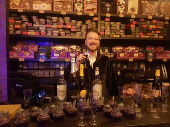 Oliver Dall behind the counter at his new wizarding shop in Brighton