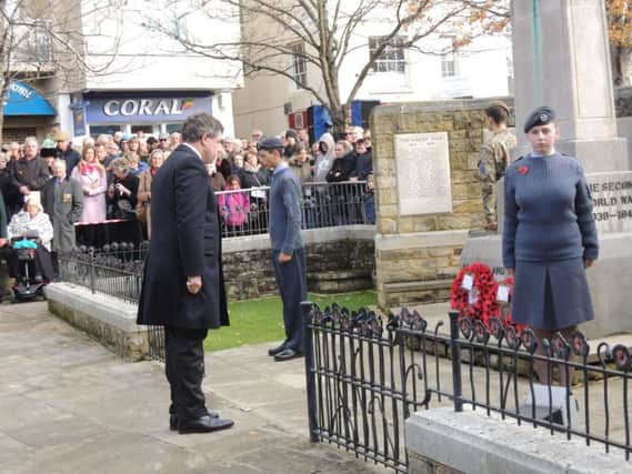 Horsham MP Jeremy Quin lays his wreath