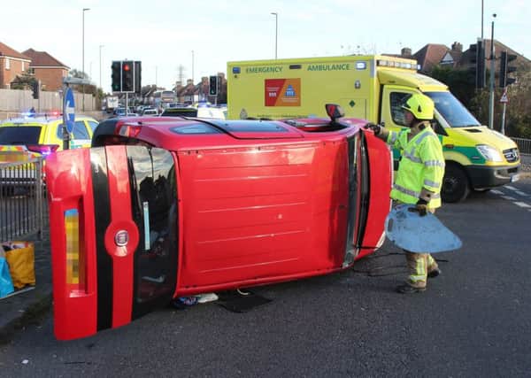 Two people had to be freed from the rolled over car. Pictures: Eddie Mitchell