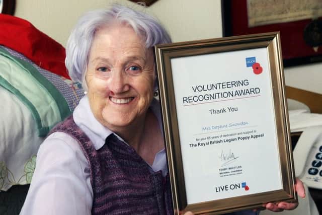 DM17112551a.jpg Poppy Appeal collector Daphne Snowden with her volunteering recognition award. Photo by Derek Martin Photography. SUS-171114-181957008
