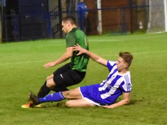 Joel Daly puts in a tackle. Haywards Heath Town v Sevenoaks Town. Picture Grahame Lehkyj