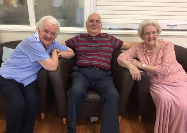 Member Maureen Smither (right) with her friends Myrtle Williams and John Alderson at the centre