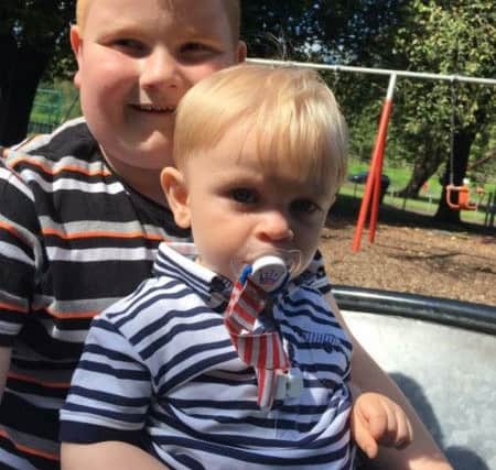 Marion Cook is searching for a necklace made from her daughter Laura Newland's ashes which has gone missing. Pictured are Laura's sons Callum, nine, and Jaxson, 16 months, who each have a paperweight made with their mum's ashes.