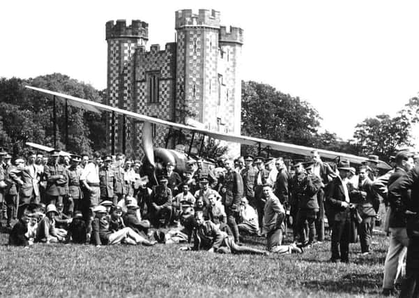Biplane next to the tower, late 1920s