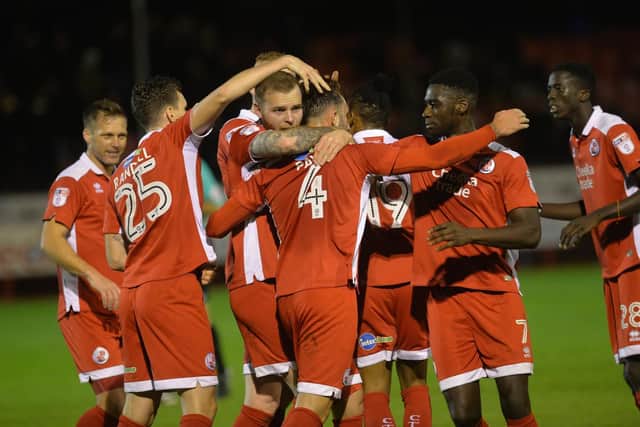 Crawley Town players congratulate Josh Payne on his penalty. Picture by Jon Rigby