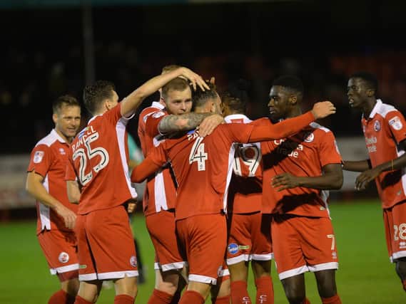 Crawley Town players congratulate Josh Payne on his penalty. Picture by Jon Rigby