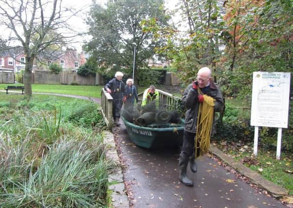 Volunteers retrieving the netting which was around the reed bed