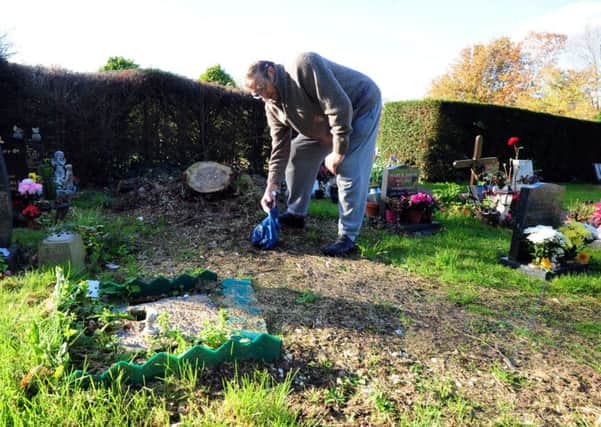 Lester Gray, 83, clearing some rubbish left at Chalcraft Lane Cemetary where his wife is buried