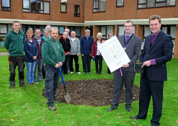 Mayor Alex Harman holds the charter and Matt French holds the tree, right, watched by residents of Guardian Court. Picture: Derek Martin DM17113293a
