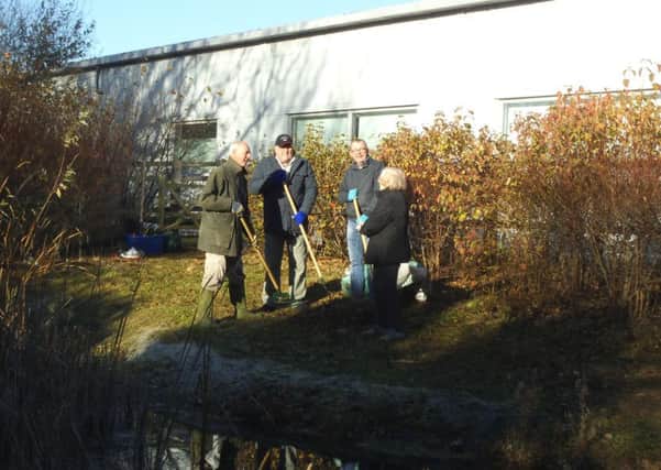 Volunteers working at the pond behind Tesco Extra