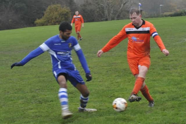 A JC Tackleway II player plays a pass against Sedlescombe Rangers II.