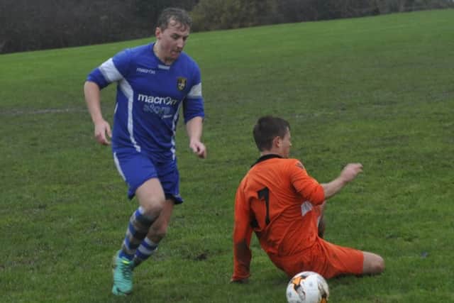 A Sedlescombe Rangers II player gets away from a sliding JC Tackleway II opponent.