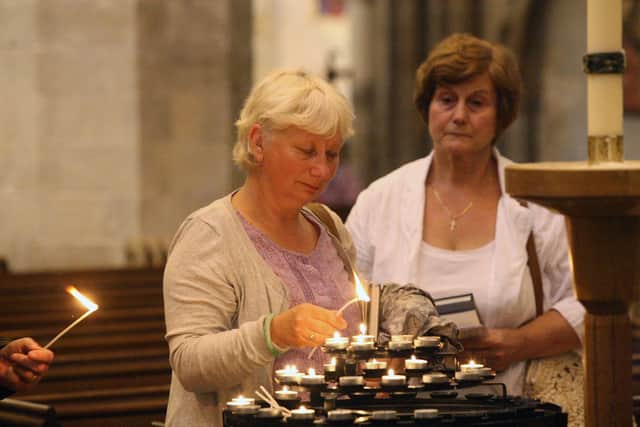 DM155928a.jpg Shoreham Airshow 2015. Lighting candles during service at St Mary's church, Shoreham. Photo by Derek Martin
